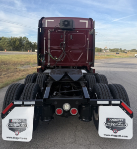 Rear view of a 2021 Freightliner Cascadia 126 tractor showing dual rear axles, mud flaps, and Doggett Freightliner branding.