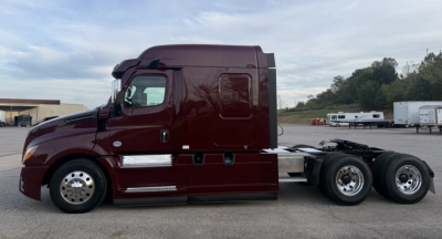 Truck side view showing Freightliner Cascadia126 sleeper cab with maroon exterior, chassis, and tandem rear axles.