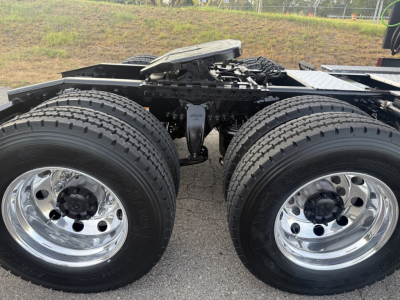 Freightliner Cascadia126 undercarriage showing rear dual axle with chrome wheels and tires, chassis components visible