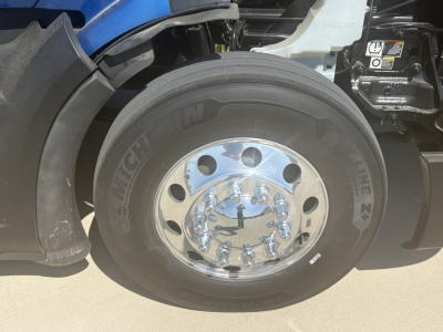 Peterbilt 579 wheel and tire close-up showing Michelin tire and chrome wheel hub with lug nuts.