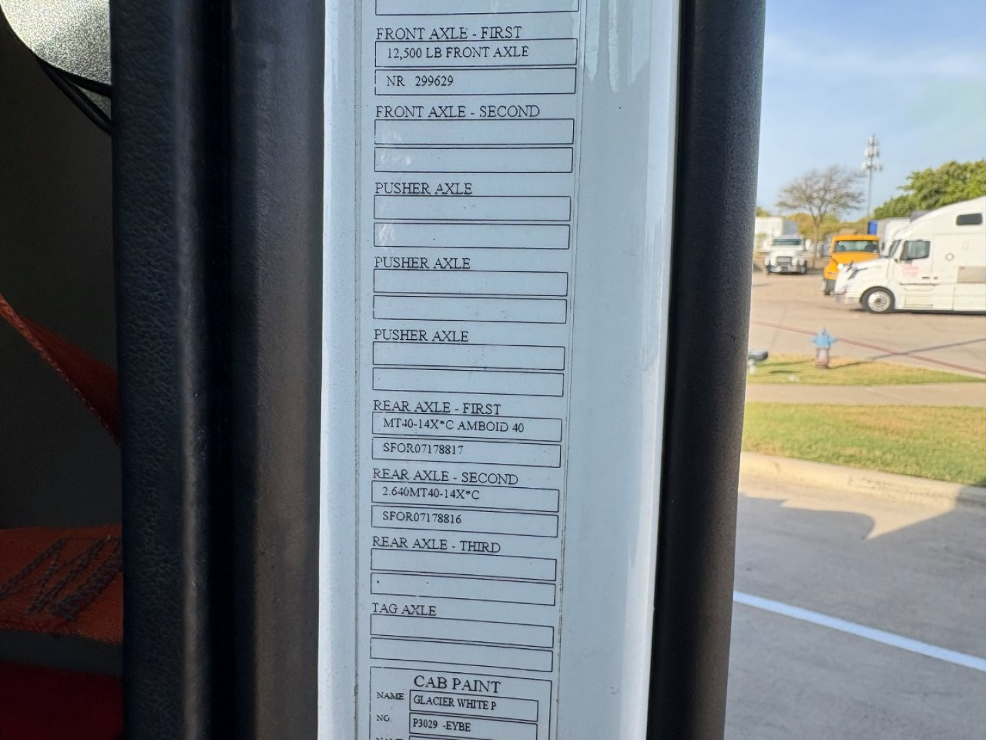 Truck cab label with axle ratings and capacities showing front and rear axle specs on a Volvo VNR daycab. Includes boxes for front axle, rear axle, and cab paint text.