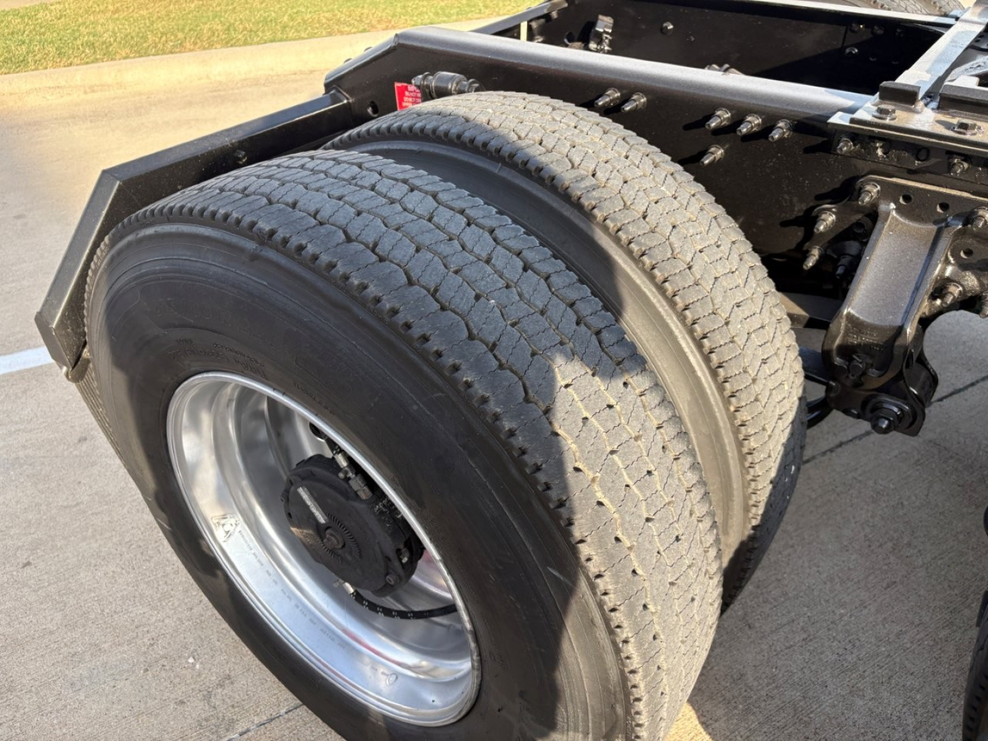 Rear dual truck tires and rear chassis of a Volvo VNR64T300, showing dual tires, wheel rims, and part of the chassis frame.