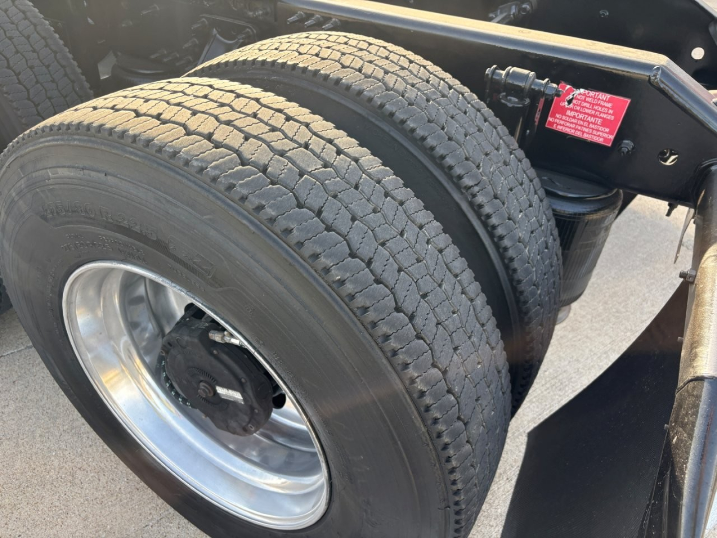 Volvo VNR64T300 truck chassis showing dual rear tires and wheel, with suspension and frame components visible.
