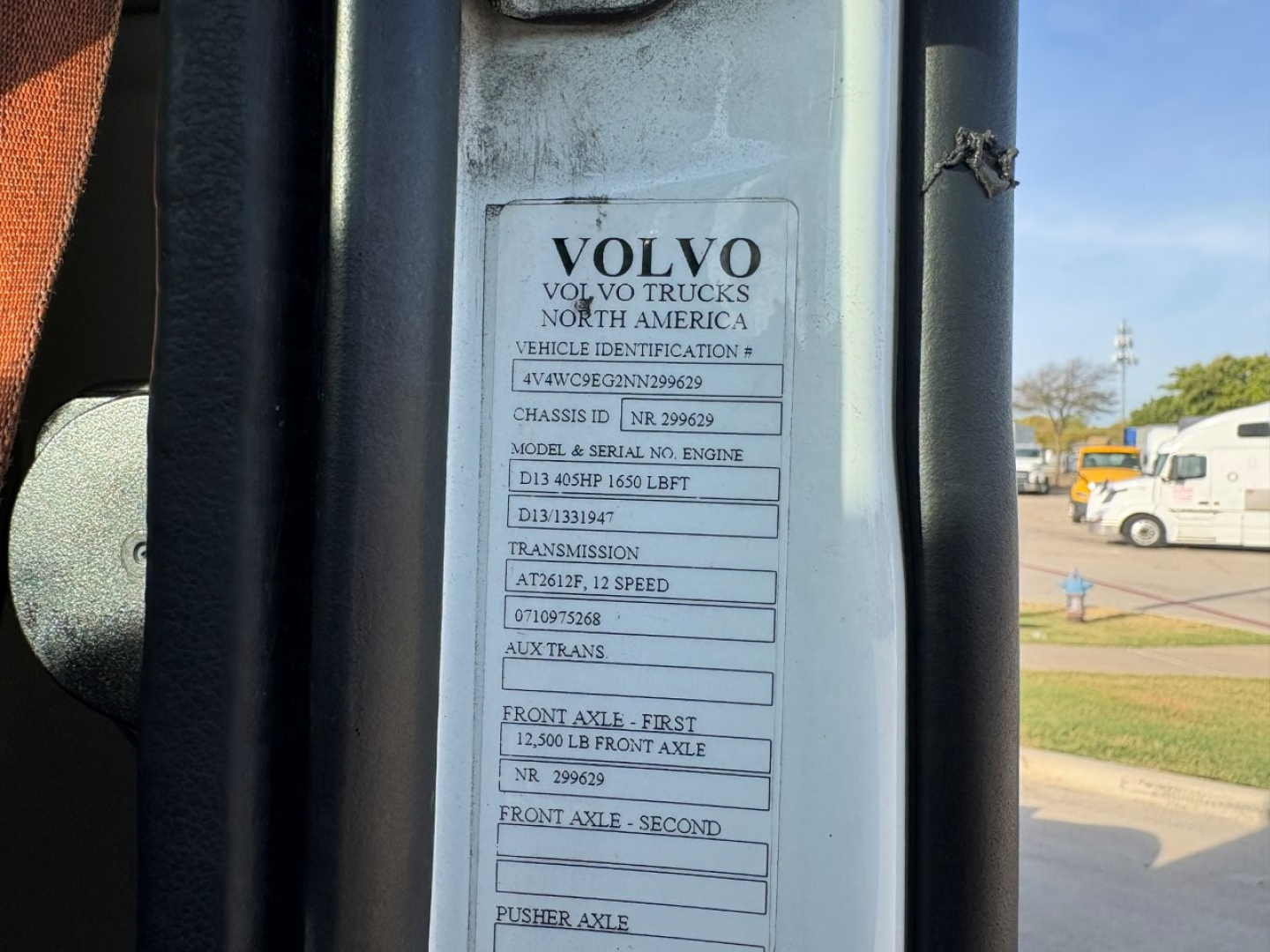 Volvo truck door jamb label showing Volvo Trucks North America vehicle identification details including chassis info, model and serial numbers, transmission, axles, and front/rear axle specs.