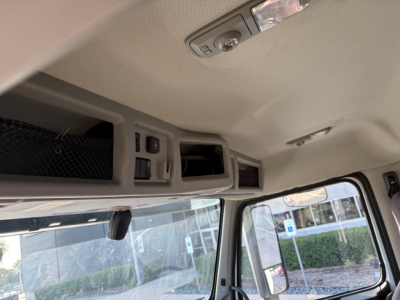 Volvo VNR truck cabin interior view showing overhead storage compartments and control panel with switches.