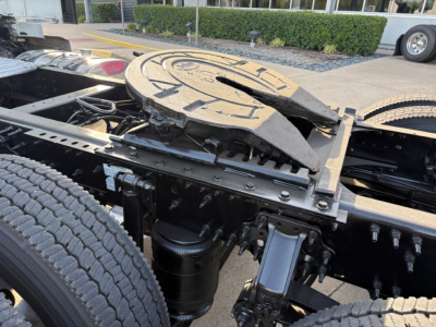Volvo truck chassis showing fifth wheel and framing with attached air tanks and suspension components.