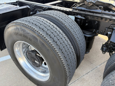 Volvo VNR64T300 truck wheel and dual rear tires showing front axle area and suspension components with clean tire treads.