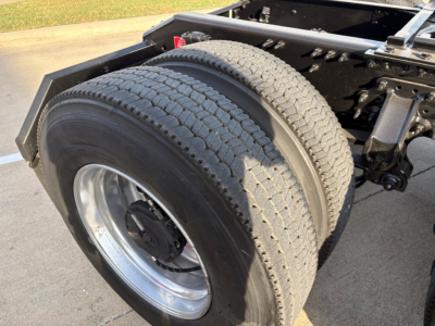 Rear dual truck tires and rear chassis of a Volvo VNR64T300, showing dual tires, wheel rims, and part of the chassis frame.