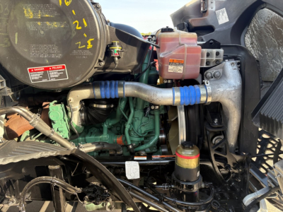 Volvo VNR64T300 engine bay showing turbocharger, coolant reservoir, and various hoses and wiring.