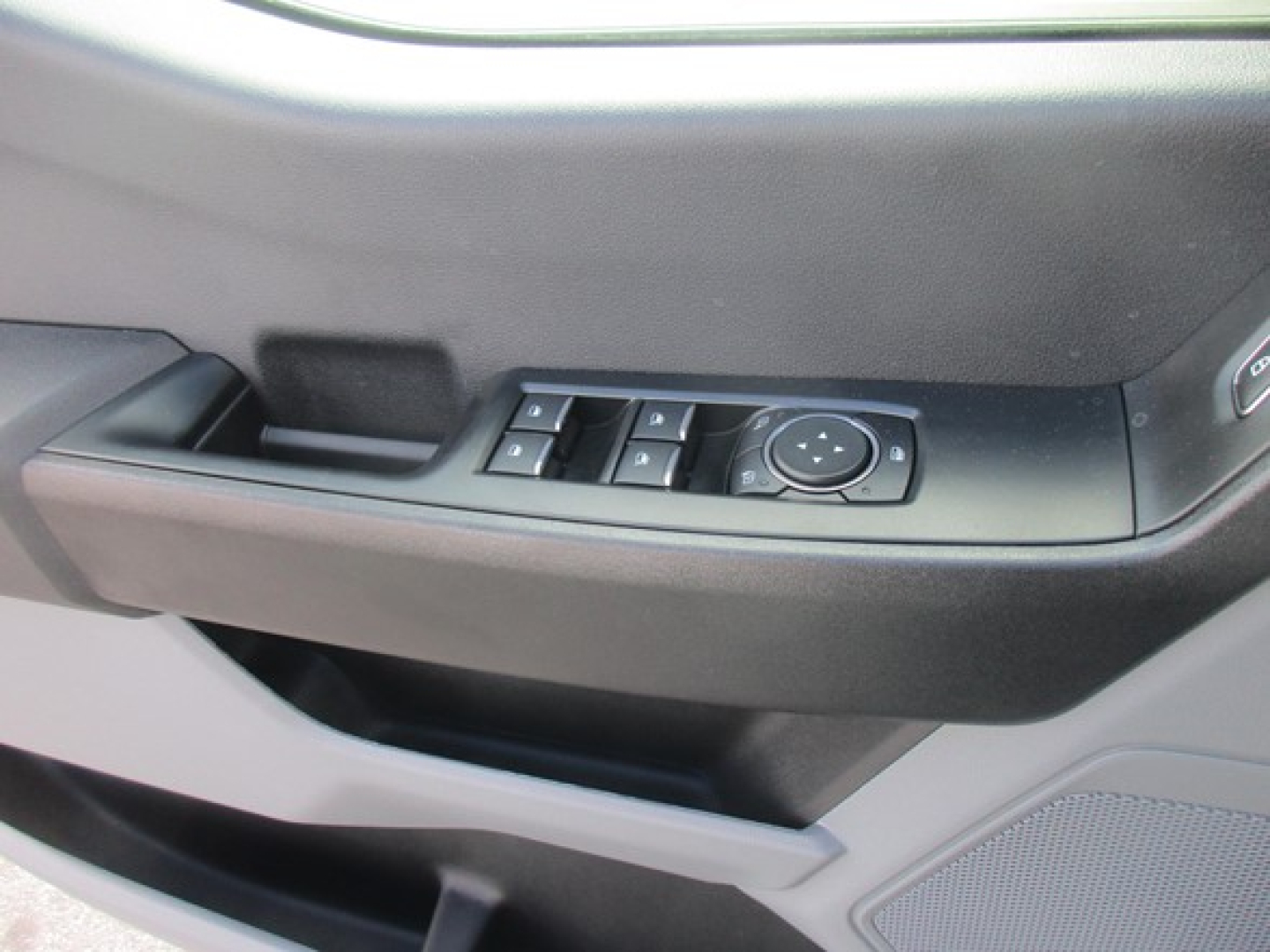Ford F-450 truck interior door controls panel with window controls and joystick-style mirror adjustment knob.