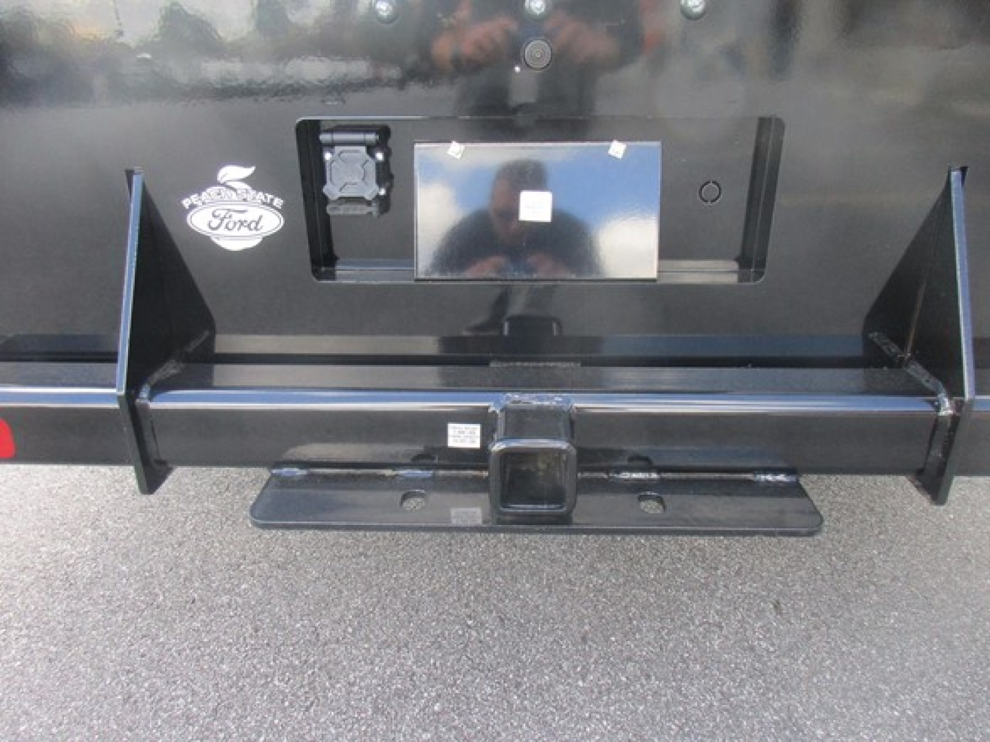 Ford F-450 cargo bed hitch receiver and bumper view showing rear of truck