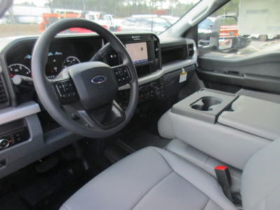Ford F-450 interior front cabin with steering wheel, dashboard, center console, and touchscreen display visible.
