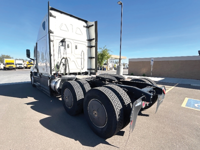 Freightliner Cascadia126 tractor rear and fifth-wheel area showing dual rear axles and exposed drive components.