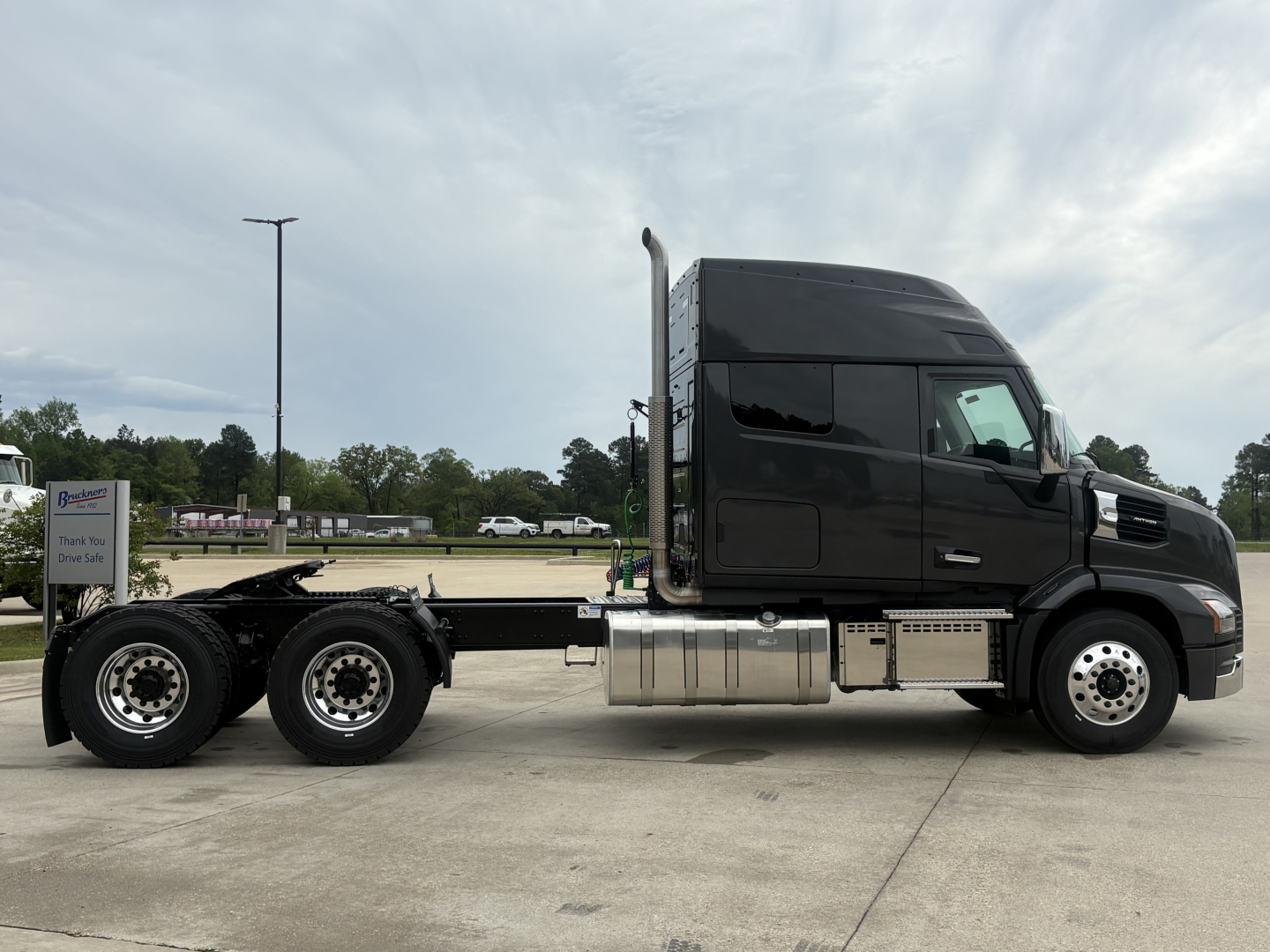 Mack AN64T64 conventional daycab tractor in profile showing cab, chassis, and aluminum fuel tanks with dual rear axles.