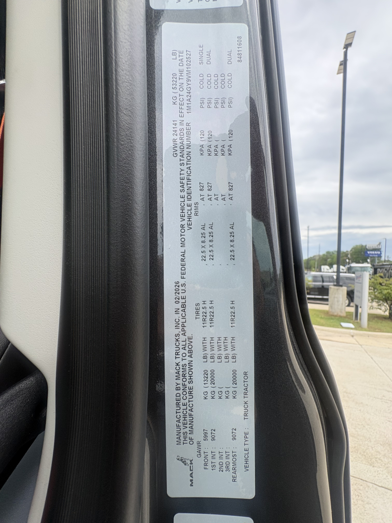 Label with vehicle specs inside door jamb for Mack AN64T64 with VIN 1M1A24GY9VM102527 and stock 72149.