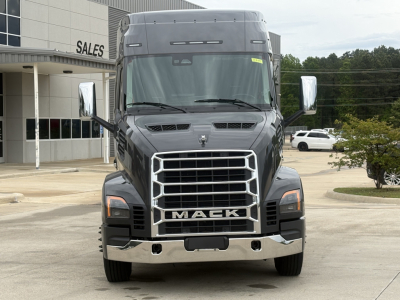 Mack AN64T64 conventional daycab truck front view with large grille and chrome bumper. Visible text includes MACK on grille. No other legible labels visible.