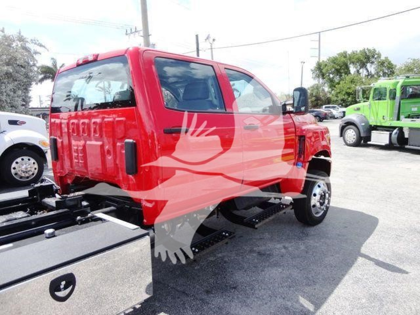 Red 2023 International CV rollback truck cab rear and side view with chassis and utility bed mounts visible.