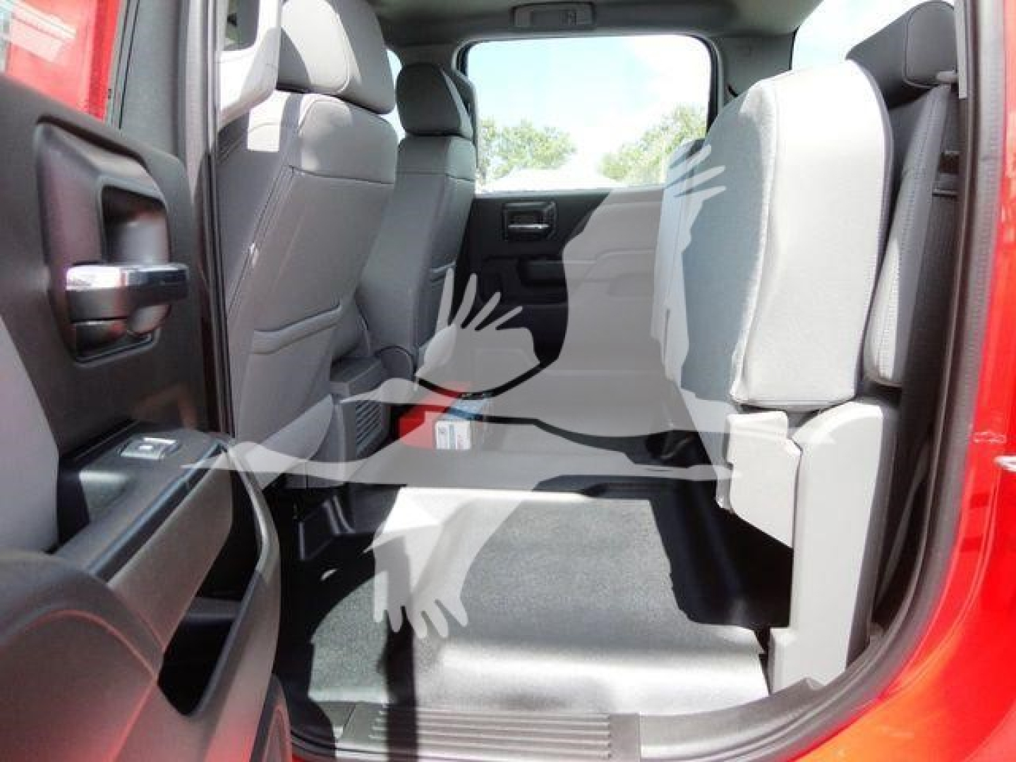 Truck interior rear seating area with rear doors open, showing gray seats and cargo space in a red vehicle.
