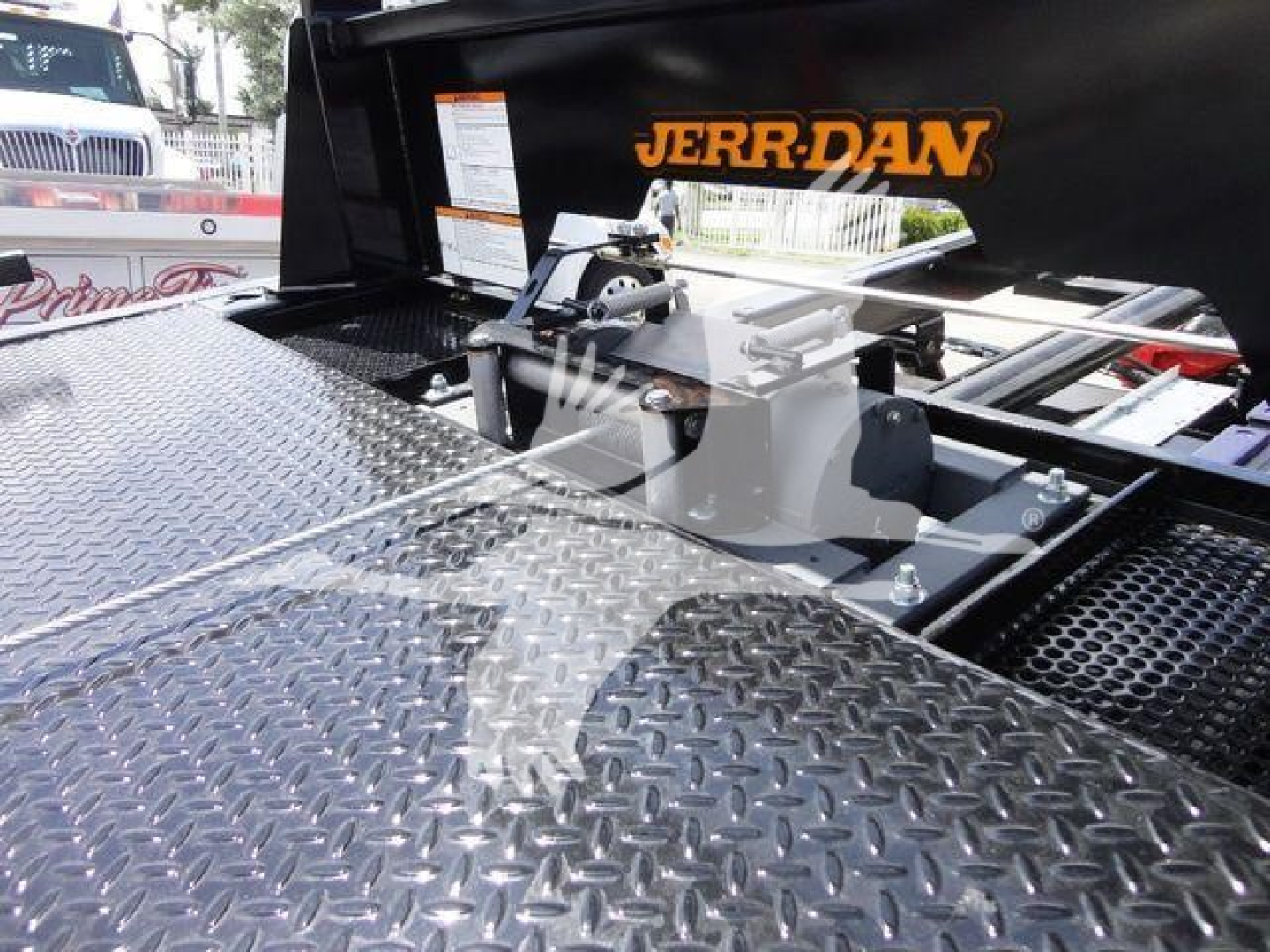 Trucks equipment in a Jerr-Dan rollback setup showing diamond plate surface and mounting hardware with orange 'JERR-DAN' logo.