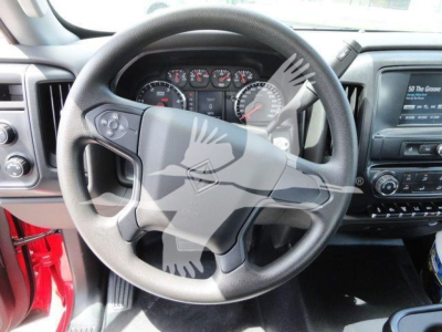 Truck cab interior focusing on steering wheel and dashboard. Steering wheel center badge and instrument cluster visible. Dashboard controls and infotainment screen to the right.