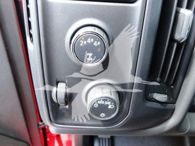 Dashboard controls of a 2023 International CV rollback truck showing 4x4 switch and transmission mode dial.
