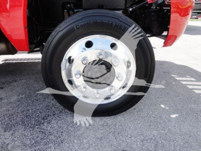 Truck wheel with Conti Hybrid HS3 tire showing chrome hub with lug nuts and wheel cover; vehicle red fender visible.