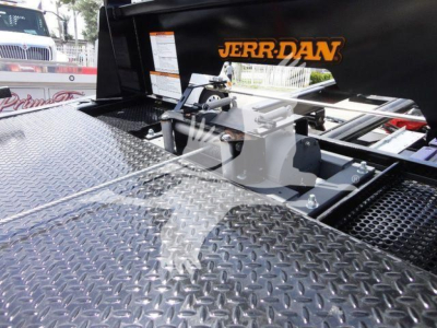 Trucks equipment in a Jerr-Dan rollback setup showing diamond plate surface and mounting hardware with orange 'JERR-DAN' logo.
