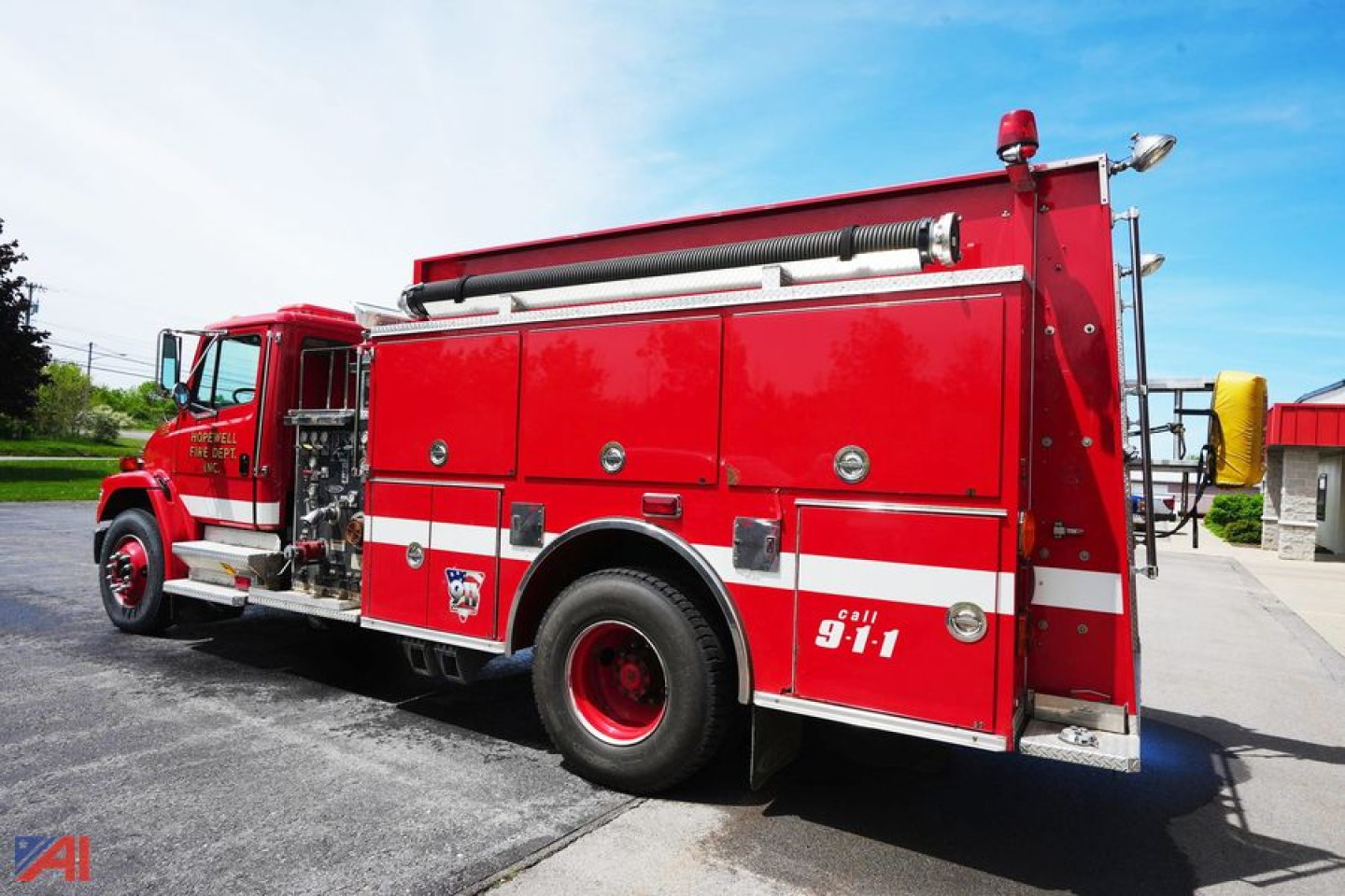 Fire truck side view showing compartments, ladder, and 911 insignia on a red 1998 Freightliner FL80 Pierce Saber Pumper