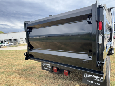 Dump truck bed of a 2025 Mack MD7 in-service showing rear dump area and taillights.