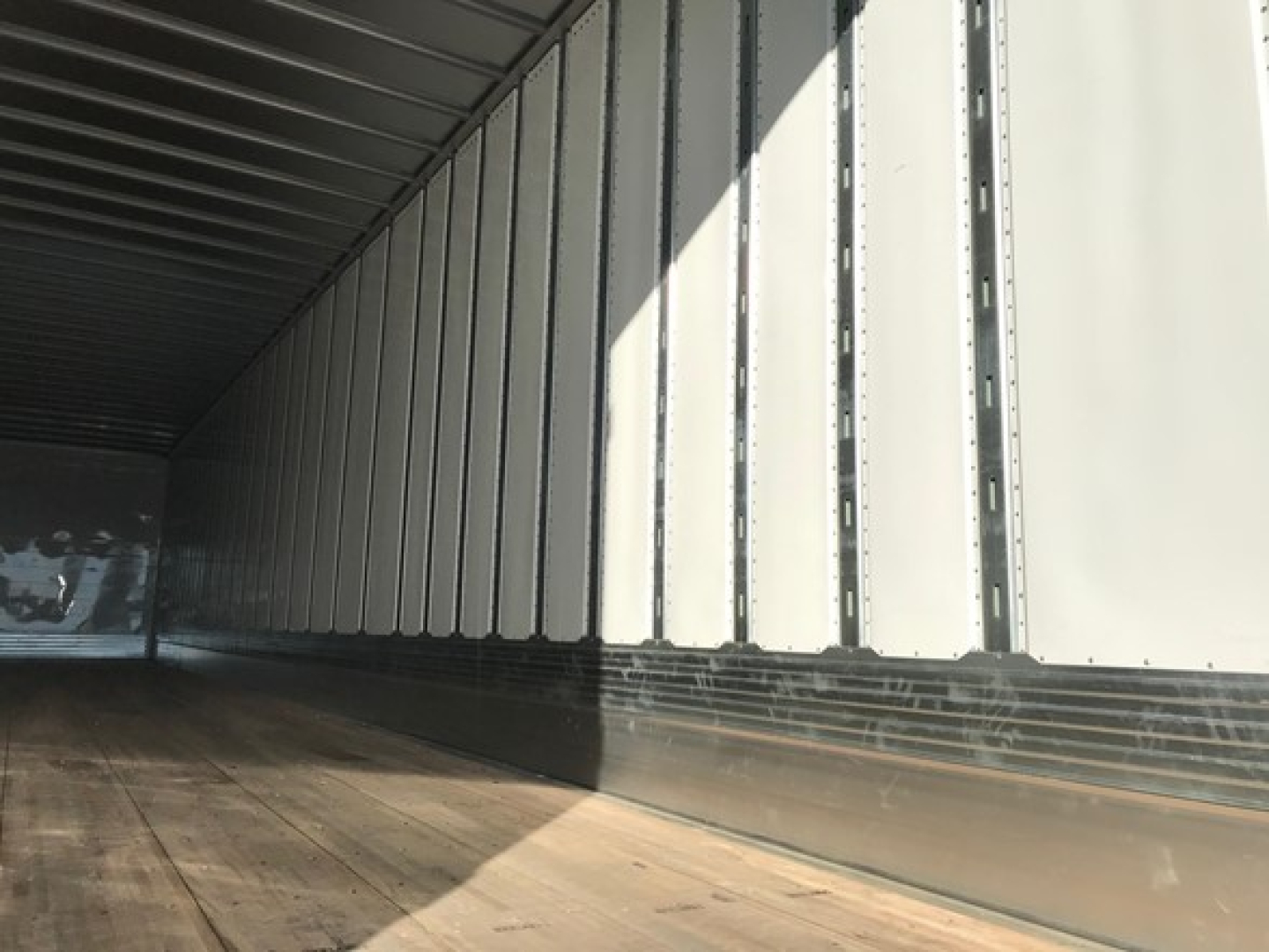 Trailer interior side wall ribs and wooden floor of a 2026 Utility 4000Dx Tbr trailer.