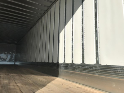 Trailer interior side wall ribs and wooden floor of a 2026 Utility 4000Dx Tbr trailer.
