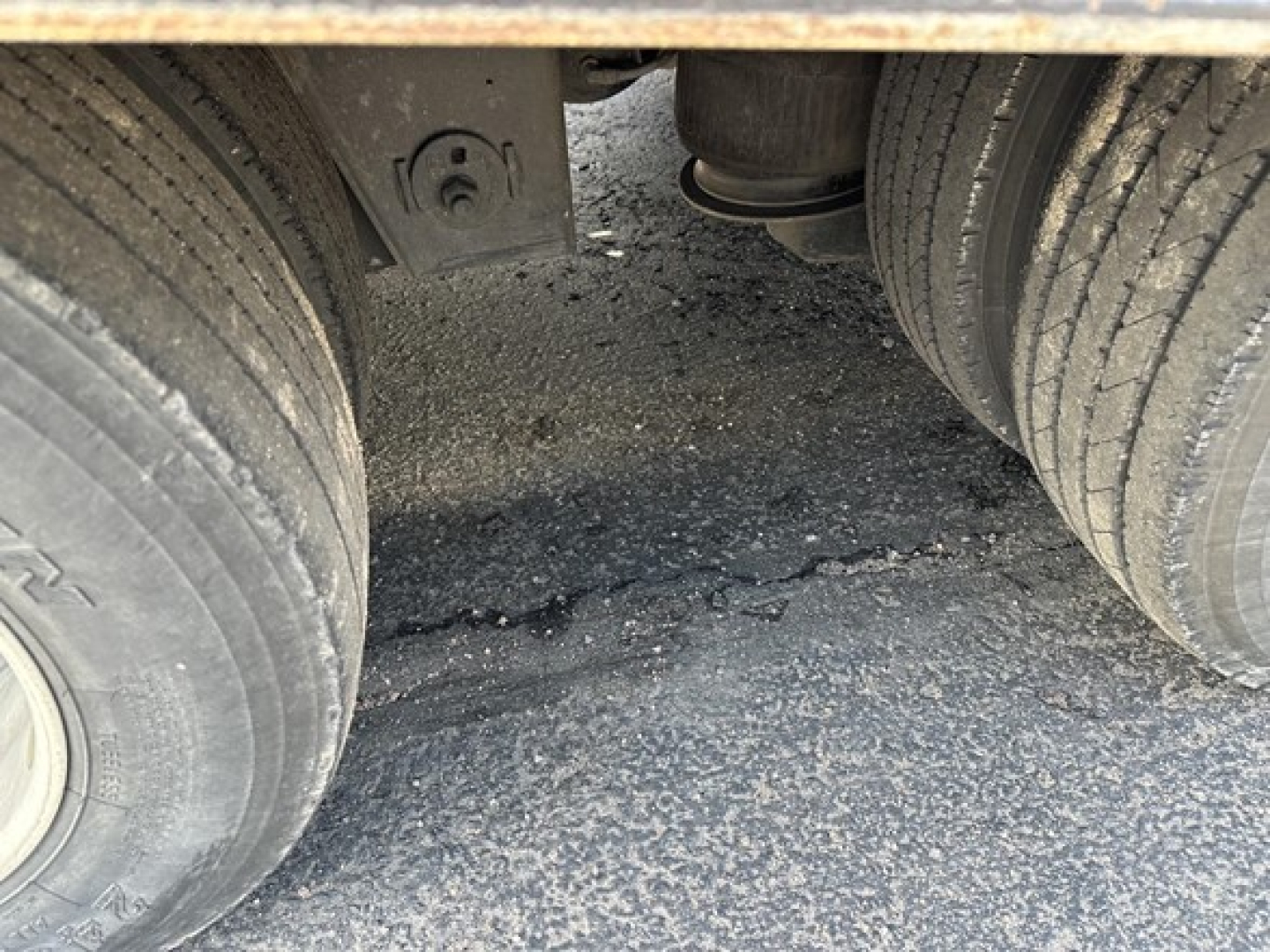 Rear view of a 40-ton slide axle recovery trailer showing dual rear tires and undercarriage components between wheels.