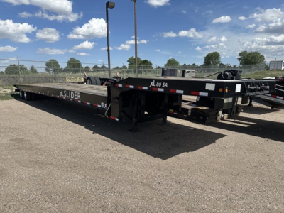 XL Specialized 40 Ton Slide Axle Recovery Trailer in-service showing flatbed with SLIDER branding and wheel chocks.