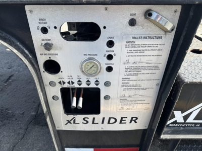 XL Specialized 40 Ton Slide Axle Recovery Trailer control panel with gauges, switches, and labels showing trailer instructions and 'XLSLIDER' branding.