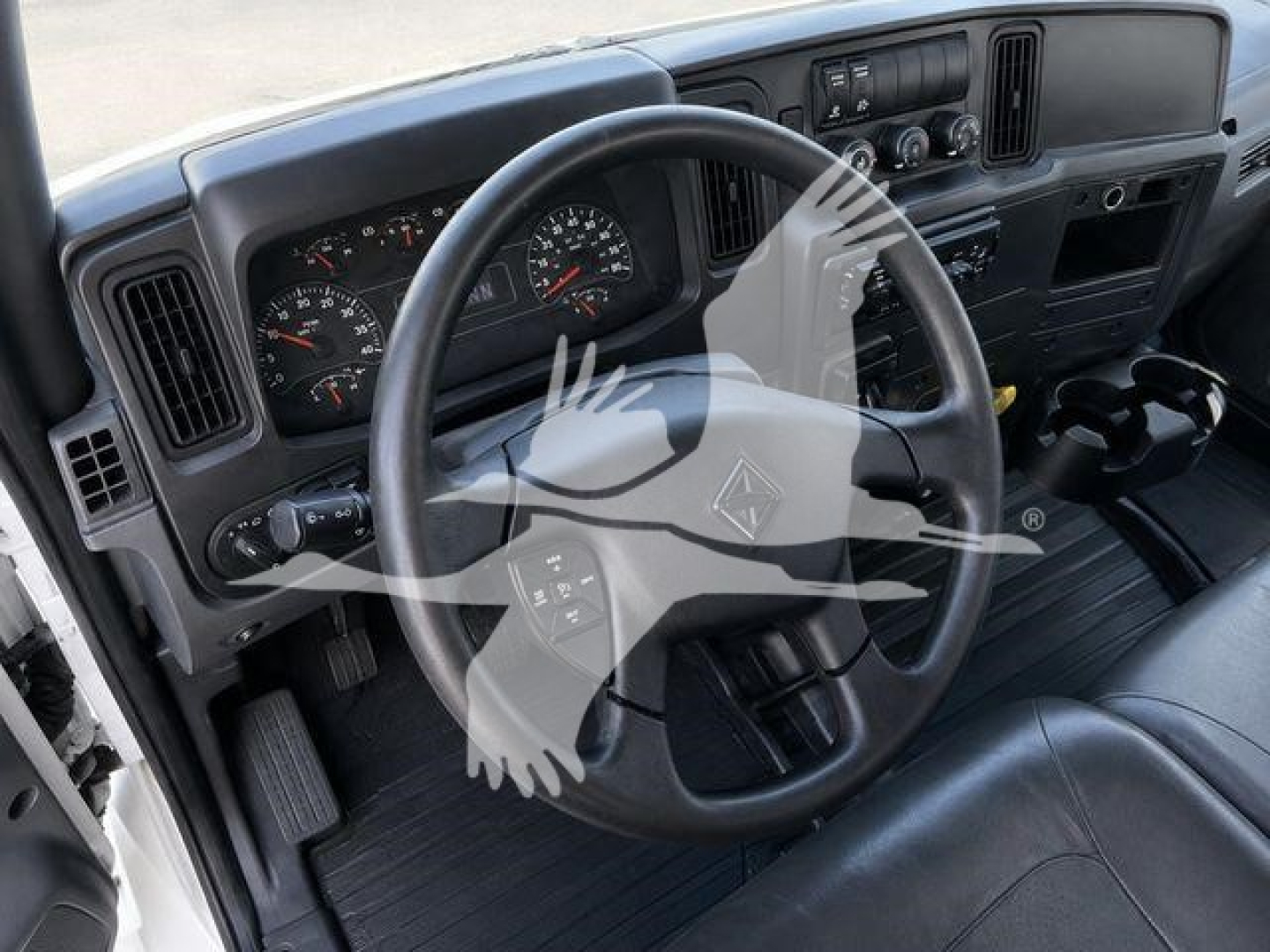 Interior view of a 2021 International MV truck cab showing steering wheel, instrument cluster, and dashboard with gauges and controls.