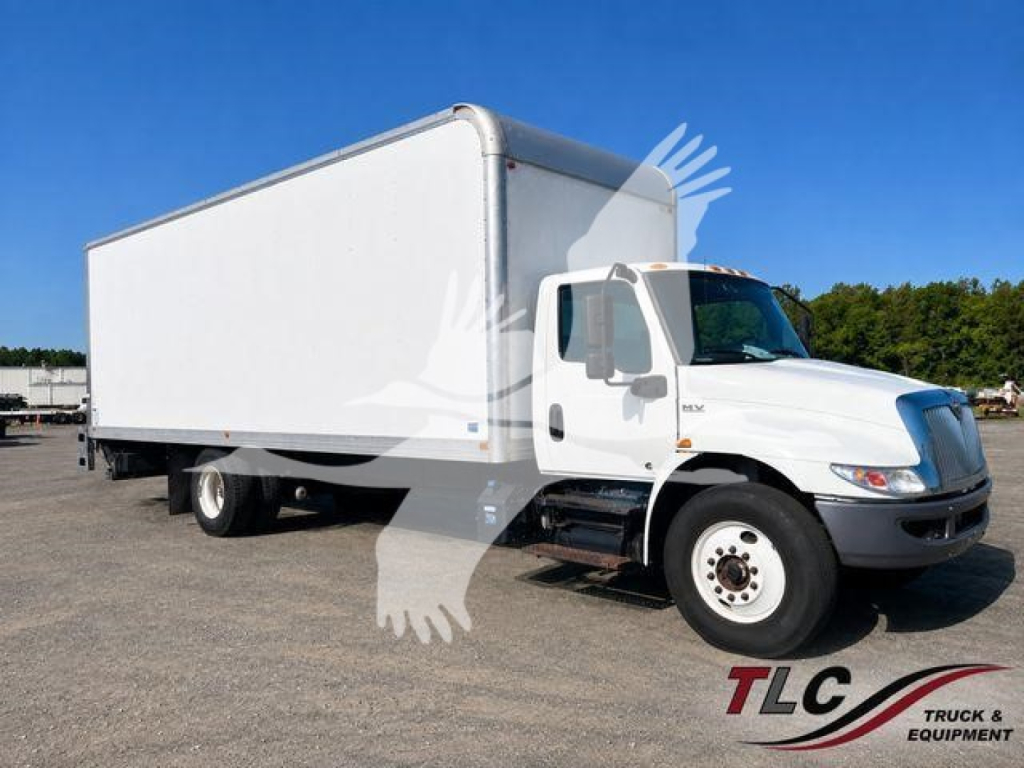 Truck in service bay showing a white box truck with cab in foreground and cargo box in background; VIN 3HAEUMML2ML402239; stock T02239; International MV box truck.