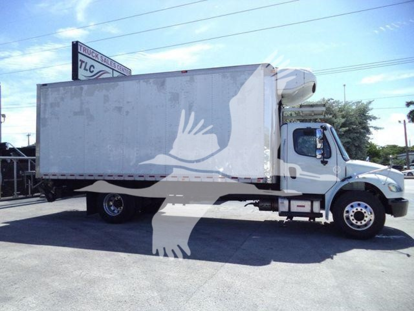 Freightliner M2 106 refrigerated truck side view showing cargo box and refrigeration unit atop cab.
