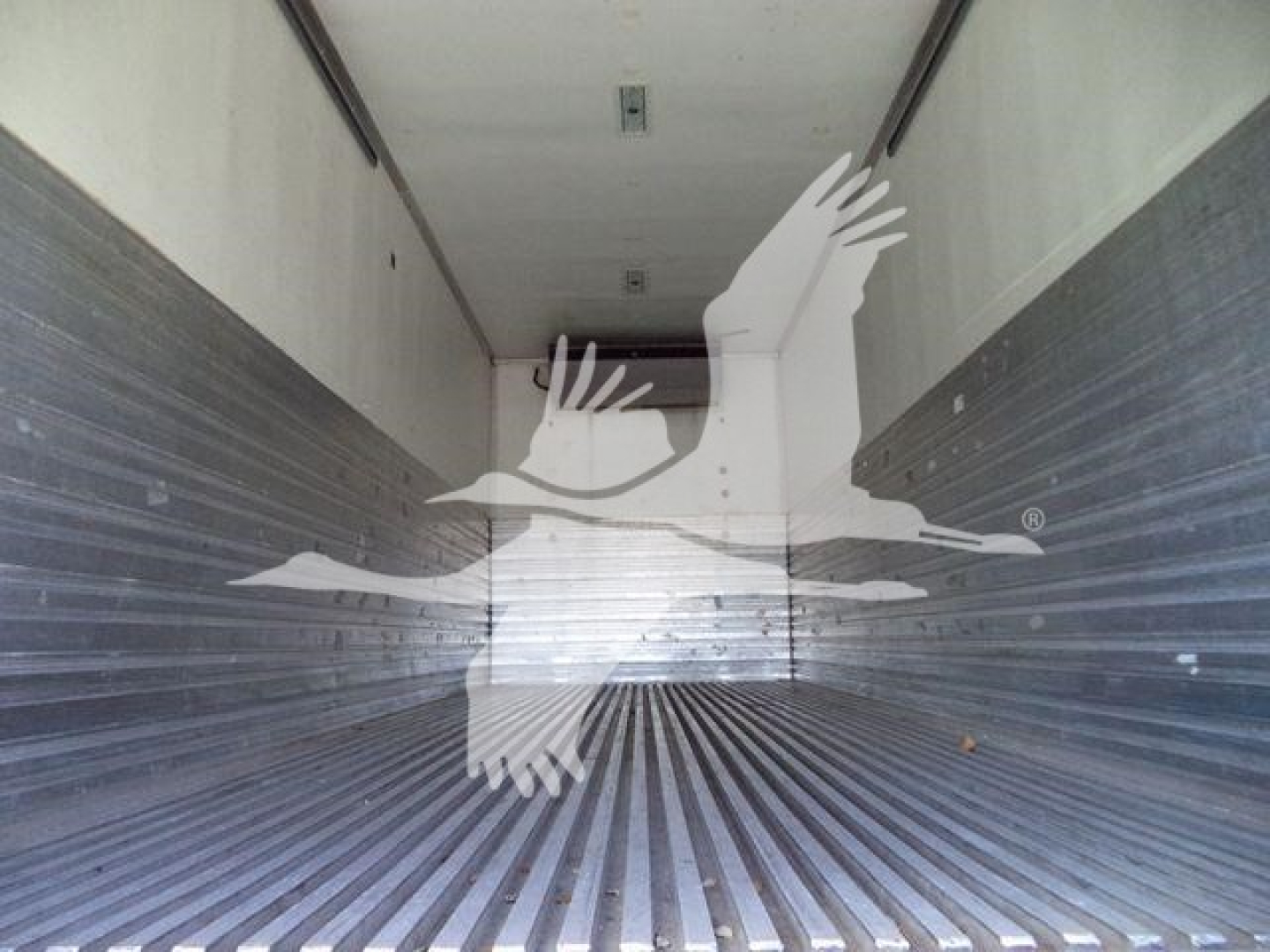Inside Freightliner M2 106 cargo area showing empty refrigerated trailer with ribbed metal walls and floor