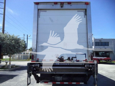 Rear view of a 2019 Freightliner M2 106 refrigerated truck showing back doors and liftgate with a white bird logo on the door.