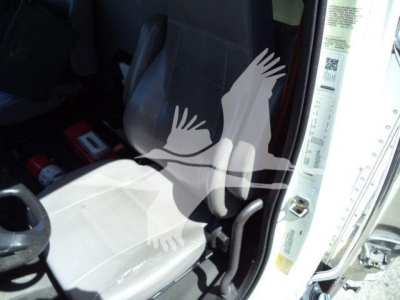 Cab interior of a 2019 Freightliner M2 106 refrigerated truck showing driver seat, steering wheel, and doorway with warning stickers.