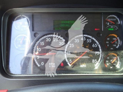 Dashboard cluster of a Freightliner M2 106 showing speedometer, tachometer, and digital readouts.