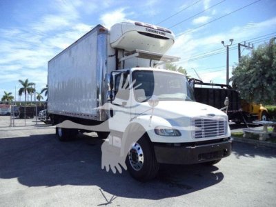 Freightliner M2 106 refrigerated truck with a lifted Thermo King unit on top, white cab, box body, parked outdoors.