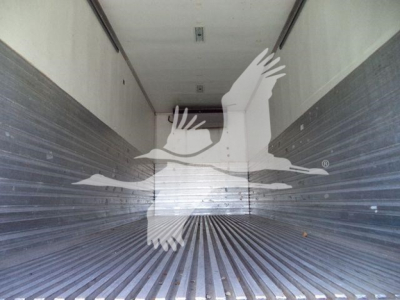 Inside Freightliner M2 106 cargo area showing empty refrigerated trailer with ribbed metal walls and floor