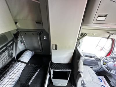 Kenworth T680 truck cab interior showing sleeper area and central storage with cabinet.