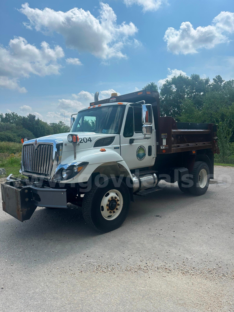 Dump truck front-left view of 2008 International 7400 with dump bed and white cab, stock number 5750-254.