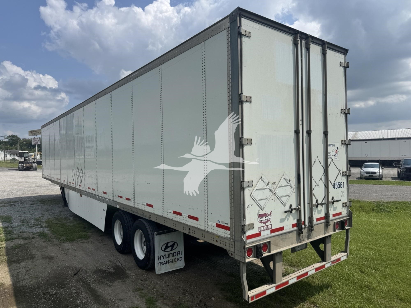 rear and side view of a 2017 Wabash dry van trailer showing triple-axle wheels and rear doors.