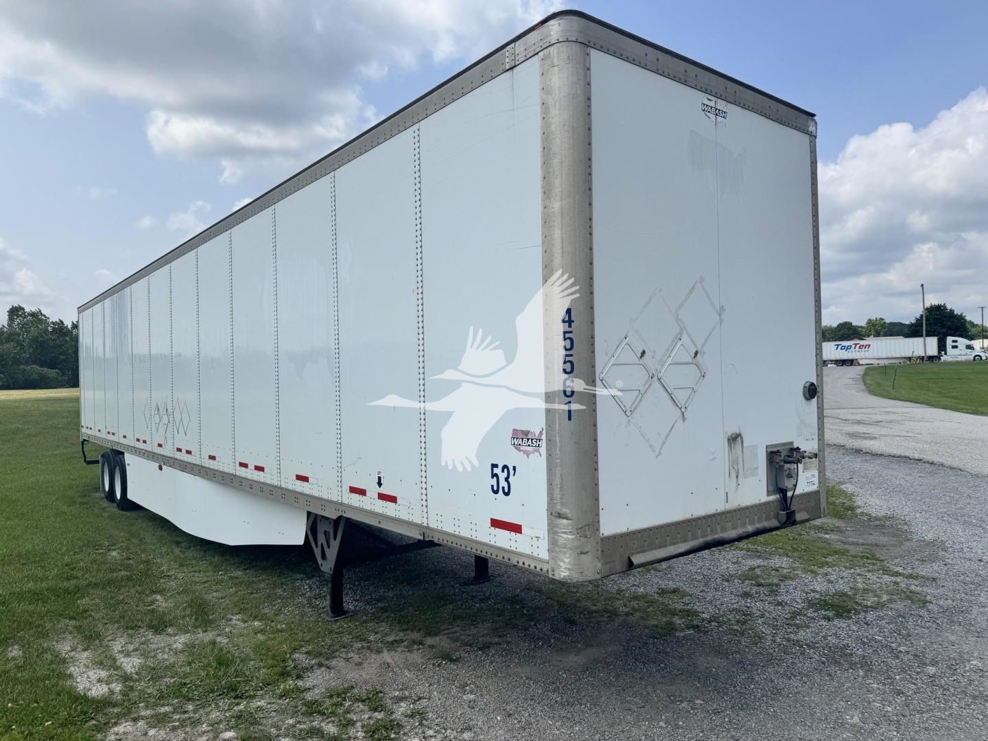 Trailer side and rear showing 53' Wabash dry van trailer with DOT stickers and rear doors.
