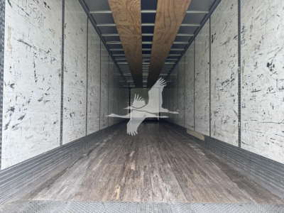 Trailer interior showing wooden floor and side walls with overhead rails, empty cargo space in a 2017 Wabash dry van.