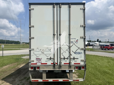 Rear view of a 2017 Wabash dry van trailer showing closed double doors with hazard placards and rear lights.