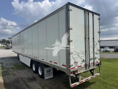 rear and side view of a 2017 Wabash dry van trailer showing triple-axle wheels and rear doors.